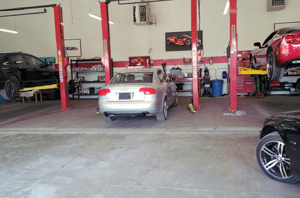 An Audi parked between the red lifts, ready to go up