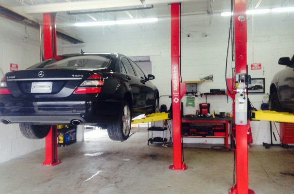 A Mercedes S 550 raised on a two post lift